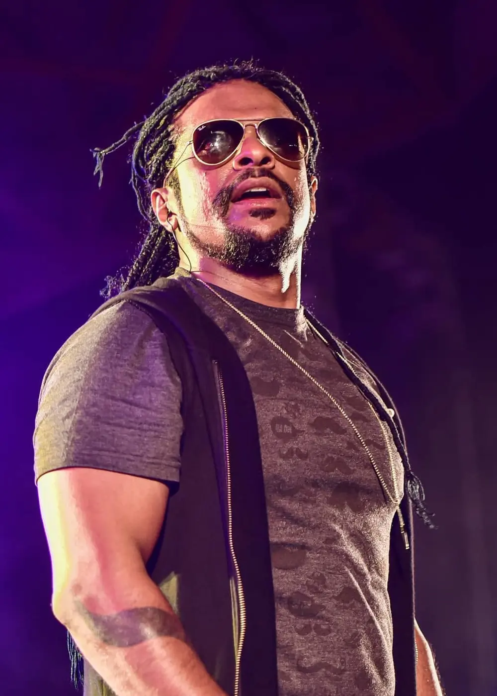 Lahiru Perera on stage in the early years, long hair, mid-song