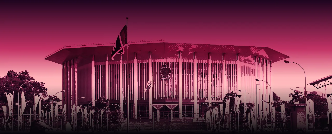 The BMICH Main Hall in Colombo, its octagonal roof and white columns under a pink dusk sky